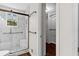 Shower with a modern glass enclosure and sleek black hardware, plus a view into a walk-in closet at 2568 Redfield Dr, Norcross, GA 30071