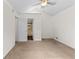 Bedroom featuring neutral carpet, white walls, ceiling fan, and an attached bathroom at 2568 Redfield Dr, Norcross, GA 30071