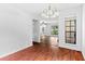 Bright dining room with hardwood floors, classic chandelier, and views into the living room at 2568 Redfield Dr, Norcross, GA 30071