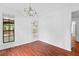 Dining area featuring hardwood floors, chandelier lighting, and a door leading to the backyard at 2568 Redfield Dr, Norcross, GA 30071