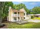 Two-story home with a stone facade, covered porch, attached garage, and lush green lawn at 2568 Redfield Dr, Norcross, GA 30071