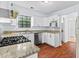 Charming kitchen featuring stainless steel appliances, granite countertops, and hardwood floors at 2568 Redfield Dr, Norcross, GA 30071