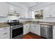 The kitchen boasts white cabinets, modern stainless steel appliances, and a window view at 2568 Redfield Dr, Norcross, GA 30071