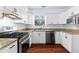 Modern kitchen with stainless steel appliances, granite countertops, and bright white cabinetry at 2568 Redfield Dr, Norcross, GA 30071