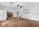 Light-filled living room featuring a stone fireplace, wood-look floors, and an open layout to the kitchen at 2568 Redfield Dr, Norcross, GA 30071