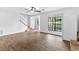 Bright living room with wood floors, a ceiling fan, large windows, and a staircase at 2568 Redfield Dr, Norcross, GA 30071