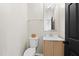 Powder room with decorative mirror, granite countertop, and black door at 3226 Masters Pass Ln, Snellville, GA 30039