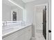 Bathroom featuring double sinks, white cabinets, and a view into a separate shower at 3226 Masters Pass Ln, Snellville, GA 30039