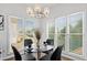 Breakfast nook with modern chandelier, large windows, and seating for four at 3226 Masters Pass Ln, Snellville, GA 30039