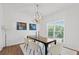 Bright dining room featuring hardwood floors, a modern chandelier, and neutral-colored furniture at 3226 Masters Pass Ln, Snellville, GA 30039