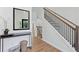 Light-filled foyer showcasing hardwood floors, staircase with iron railing, and modern console table at 3226 Masters Pass Ln, Snellville, GA 30039