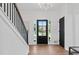 Bright foyer with hardwood floors, staircase, and stylish black front door at 3226 Masters Pass Ln, Snellville, GA 30039