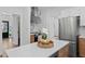Well-lit kitchen with stainless steel appliances, white counters and wood-look flooring at 3226 Masters Pass Ln, Snellville, GA 30039