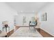 Bright living room featuring hardwood floors, a glass desk, and neutral decor at 3226 Masters Pass Ln, Snellville, GA 30039