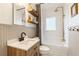 Charming bathroom featuring a shower-tub combo, subway tile walls, a wood vanity, and elegant fixtures at 67 Trammell Sw St, Marietta, GA 30064