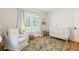 Inviting Bedroom with a crib, chair, and bright windows, creating a serene and welcoming space for a  at 67 Trammell Sw St, Marietta, GA 30064
