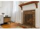 Close up on a fireplace with brick surround and vintage metal screen at 67 Trammell Sw St, Marietta, GA 30064