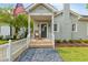 Inviting covered front porch with rocking chair and American flag creating a welcoming entrance to the home at 67 Trammell Sw St, Marietta, GA 30064