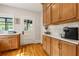 Kitchen featuring classic oak cabinets, white countertops, and hardwood floors at 67 Trammell Sw St, Marietta, GA 30064