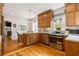 Open kitchen layout featuring stainless steel appliances, wooden cabinets, and access to the dining area at 67 Trammell Sw St, Marietta, GA 30064