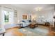 Bright living room featuring hardwood floors, neutral decor, and large windows providing natural light at 67 Trammell Sw St, Marietta, GA 30064