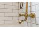 Close-up of stylish brass shower fixtures against white subway tiles, providing a luxurious bathing experience at 67 Trammell Sw St, Marietta, GA 30064
