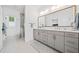 Modern bathroom with dual vanities, a large mirror, and a glass-enclosed shower at 1045 Endeavour Ct, Marietta, GA 30064