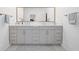 Bright bathroom featuring a double vanity with gray cabinets, a white countertop, and a large mirror at 1045 Endeavour Ct, Marietta, GA 30064