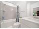 Clean bathroom with a shower-tub combo featuring a shower curtain and neutral tile at 1045 Endeavour Ct, Marietta, GA 30064