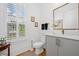 Stylish powder room featuring shuttered window, sleek vanity, and elegant fixtures at 1045 Endeavour Ct, Marietta, GA 30064