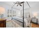 Tranquil bedroom with a four-poster bed, soft linens, and large windows offering plenty of natural light at 1045 Endeavour Ct, Marietta, GA 30064