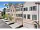 Row of townhouses featuring a brick and siding exterior, garages, and manicured landscaping at 1045 Endeavour Ct, Marietta, GA 30064
