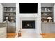 Cozy fireplace with built-in shelving and cabinets with TV and decorative mantle pieces at 1045 Endeavour Ct, Marietta, GA 30064