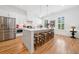 A modern kitchen features stainless steel appliances, a large island with seating, and natural light at 1045 Endeavour Ct, Marietta, GA 30064