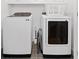 Bright laundry room with a white front-load washer and dryer set and white overhead cabinets at 1045 Endeavour Ct, Marietta, GA 30064