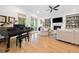 Spacious living room with a grand piano, fireplace, built-in shelving and bright windows at 1045 Endeavour Ct, Marietta, GA 30064