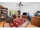 Cozy living room with hardwood floors, a ceiling fan, and bookshelves for relaxing and entertaining at 1045 Endeavour Ct, Marietta, GA 30064