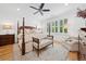 Spacious main bedroom with a four-poster bed, neutral decor, and natural light from shuttered windows at 1045 Endeavour Ct, Marietta, GA 30064