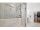Walk-in shower featuring glass door, neutral tile, and adjoining walk-in closet at 1045 Endeavour Ct, Marietta, GA 30064