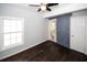 Bedroom featuring dark hardwood floors, natural light, and barn door entry to bathroom at 1110 Mcdaniel Sw St, Atlanta, GA 30310