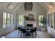 Bright dining room with a fireplace, large windows, a vaulted ceiling, and a modern light fixture at 1303 Cobblemill Nw Way, Kennesaw, GA 30152