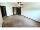 A spacious bedroom featuring a ceiling fan, carpeted floor and ample natural light at 3100 Karen Ne Ln, Marietta, GA 30062