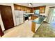 Kitchen featuring wood cabinetry, appliances, and a breakfast bar connecting to living room at 3100 Karen Ne Ln, Marietta, GA 30062