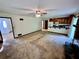 Living room with a ceiling fan, fireplace, and access to the kitchen and front entrance at 3100 Karen Ne Ln, Marietta, GA 30062