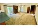 Spacious living room featuring a stone fireplace, ceiling fan and access to a deck at 3100 Karen Ne Ln, Marietta, GA 30062