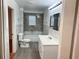Bathroom with gray tile features modern fixtures at 701 Cameron M Alexander Nw Blvd, Atlanta, GA 30318
