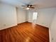 A bright bedroom with wood-look floors, white walls, and a view into the hallway at 701 Cameron M Alexander Nw Blvd, Atlanta, GA 30318