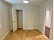Bedroom with wood floors and a closet with white door at 701 Cameron M Alexander Nw Blvd, Atlanta, GA 30318