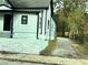 Exterior view of a home with white siding, black trim, and a driveway on the side at 701 Cameron M Alexander Nw Blvd, Atlanta, GA 30318