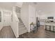 Inviting entryway showcases staircase, modern decor, and seamless flow to the kitchen at 1315 Aura Ln, Lawrenceville, GA 30045